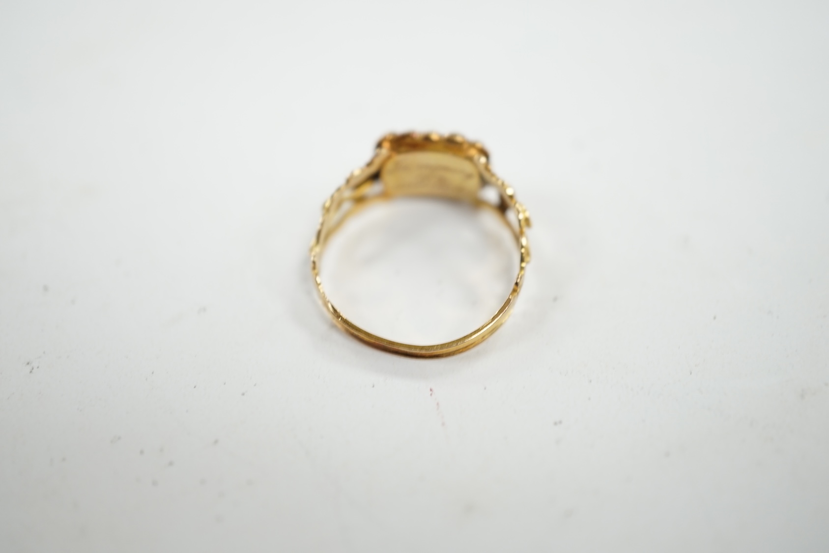 A 19th century yellow metal, seed pearl and plaited hair set mourning ring, the ring head verso inscribed 'In memory of a dear sister', size J, gross weight 1.4 grams. Condition - fair